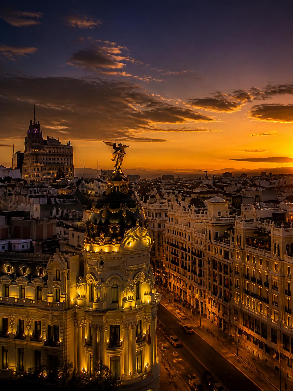 Gran Vía and the Metropolis building in Madrid at golden dusk